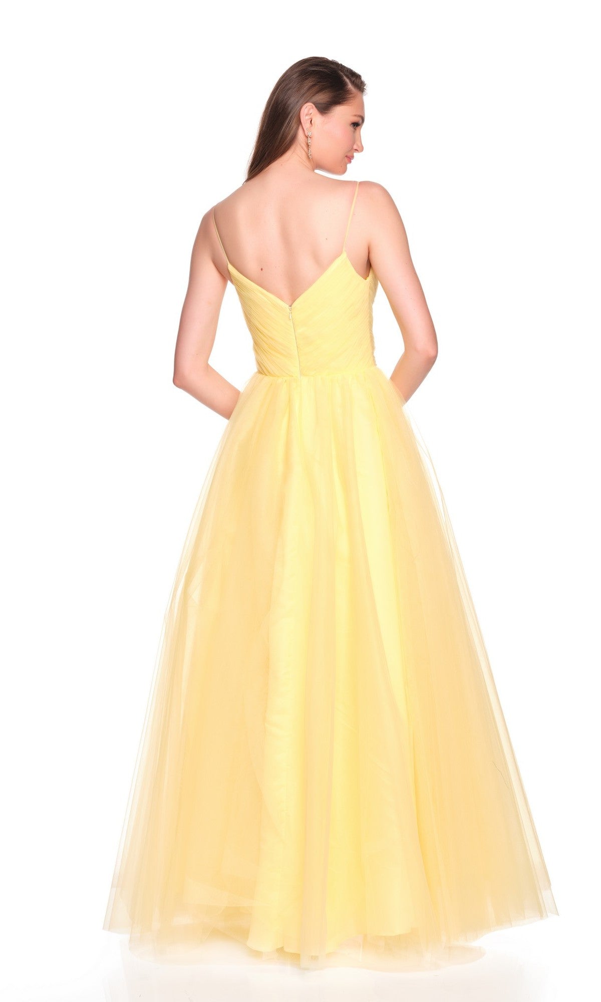 Woman facing away from the camera in the Dave and Johnny 12580 long prom dress, which features a yellow tulle A-line skirt and thin straps, set against a plain white background.